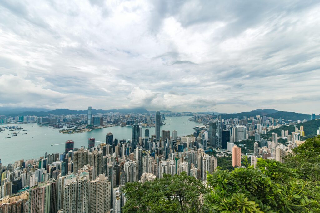 A breathtaking aerial panorama of Hong Kong's iconic skyline with towering skyscrapers and Victoria Harbour.